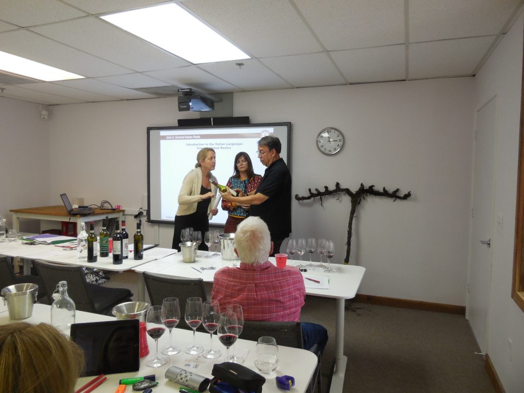 Catherine Bugue, D.W.S, heping IWP students to decipher a wine label